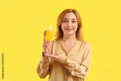 Mature woman with glass of ...