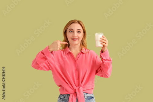 Mature woman pointing at gl...