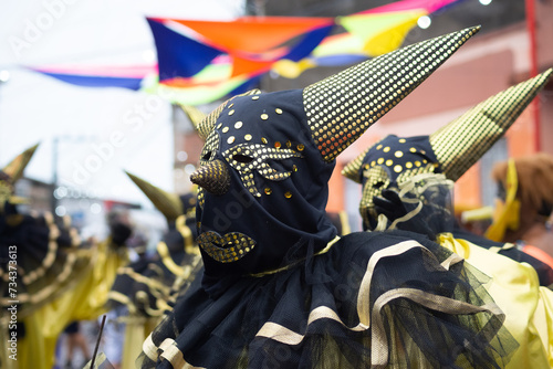 People wearing Venetian carnival-style masks are seen during the carnival in the city of Maragogipe, in Bahia.