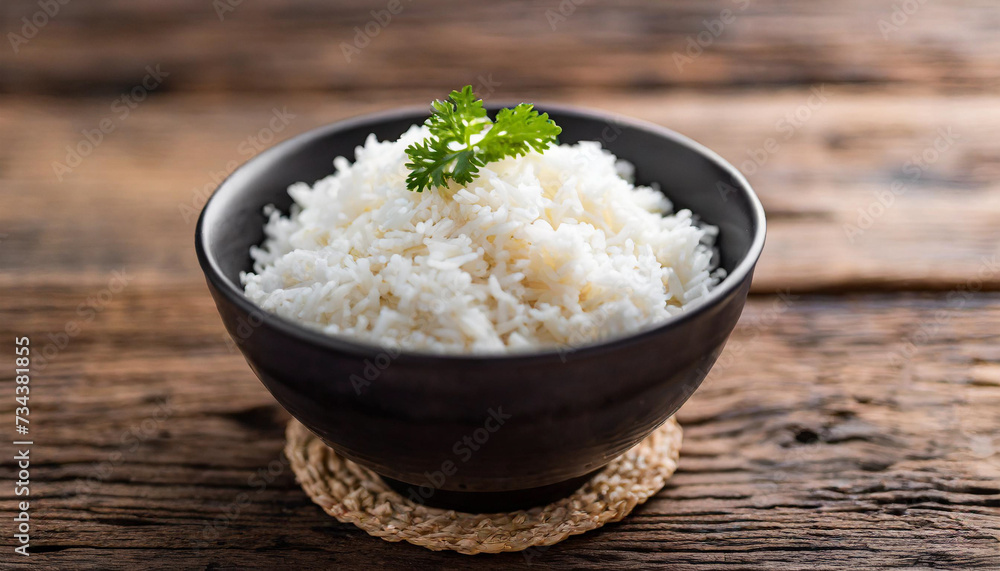 Cooked rice in bowl on wooden background, symbolizing nutrition, sustenance, Asian cuisine. Copy space for food-related concepts Cooked rice in bowl on wooden background, symbolizing nutrition, sustenance, Asian cuisine. Copy space for food-related concepts