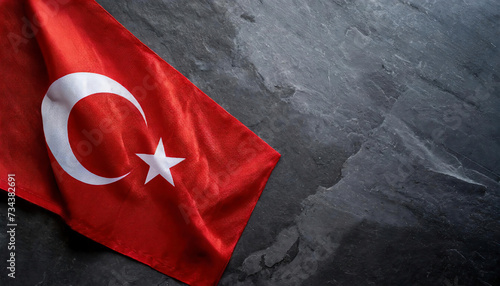 Waving Turkish flag on a dark stone background. copy space for text