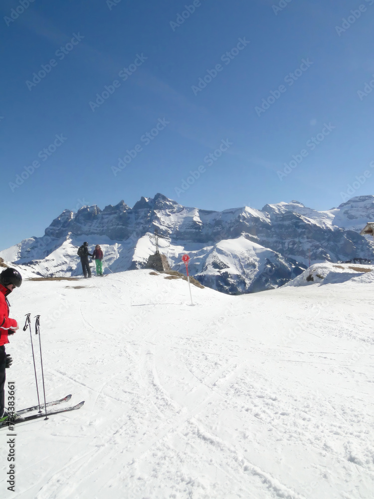 Skiers take a break to view the Dents du Midi