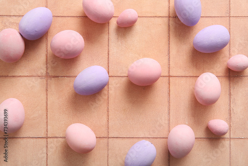 Painted Easter eggs on pink tile background