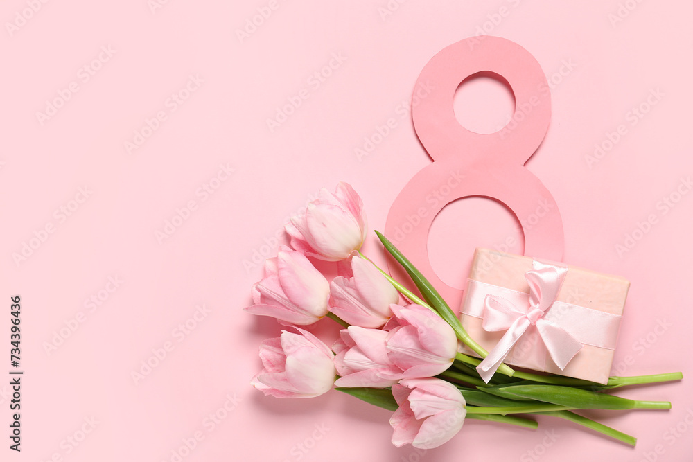 Figure 8 made of paper with beautiful tulips and gift box on pink background. International Women's Day Figure 8 made of paper with beautiful tulips and gift box on pink background. International Women's Day