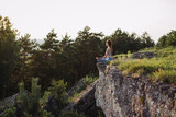 Young woman practicing yoga at sunset in a beautiful mountain location.