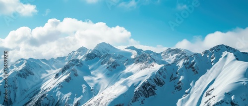 Breathtaking Snowy Mountain Peaks Under Blue Sky