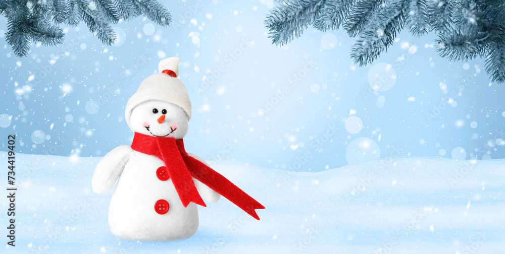 Fototapeta premium Cute decorative snowman in hat and scarf outdoors on snowy day, space for text. Banner design