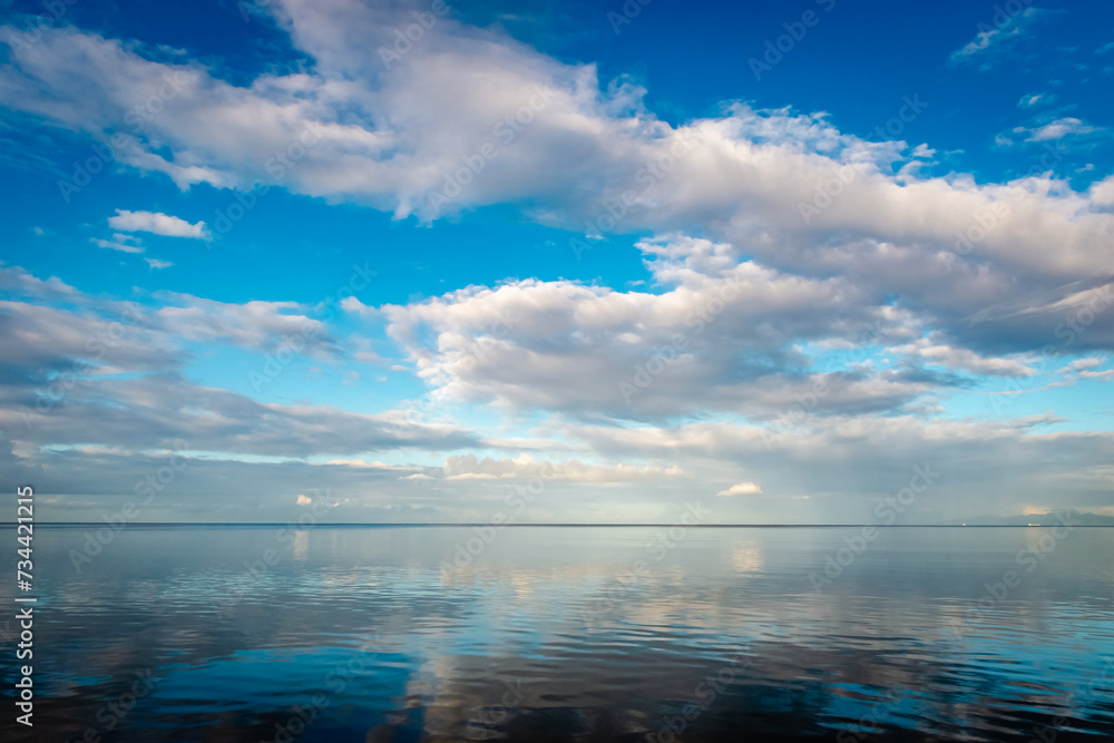 Calm sea and sky reflection morning dawn open space surface in Trinidad and Tobago