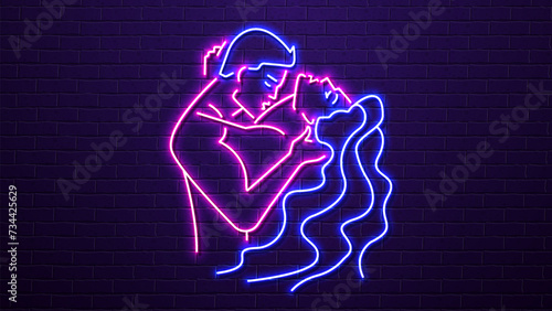 Neon silhouettes of a man and a woman kissing against a brick wall. A concept for a sex shop and erotica. photo