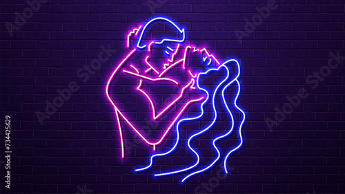 Neon silhouettes of a man and a woman kissing against a brick wall. A concept for a sex shop and erotica.