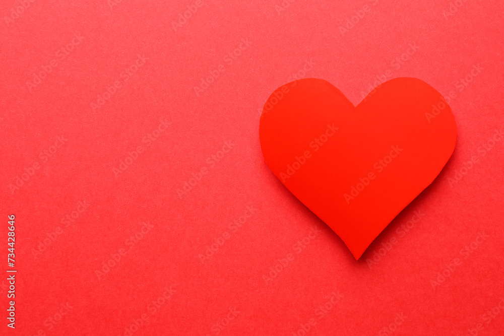One paper heart on red background, top view. Space for text One paper heart on red background, top view. Space for text