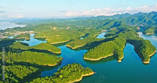 Aerial video of green forest and mountain with lake natural landscape in Hangzhou. Beautiful mountain and water landscape in summer. Drone surround shooting. photo