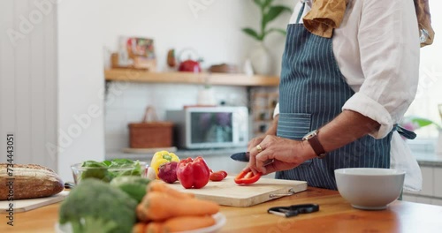 Cooking, hands and man with healthy food for meal prep, nutrition and cutting fresh ingredients for lunch. Diet, vegetables and home chef at kitchen counter with knife, recipe and salad for dinner. photo