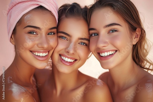 A group of stylish young women with beaming smiles and glossy lips, radiating love and happiness as they pose in front of a vibrant wall, showcasing their fashionable clothing and feminine beauty