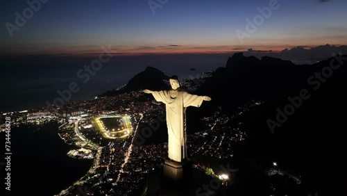 Sunset Christ The Redeemer At Rio De Janeiro Brazil. Sculpture Aerial. Town Sky Illumination Urban. Town Outside Illumination Downtown Panorama. Town Urban City Landmark. Rio de Janeiro Brazil. photo