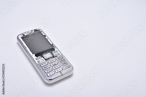 white classic mobile phone with keypad isolated on white background