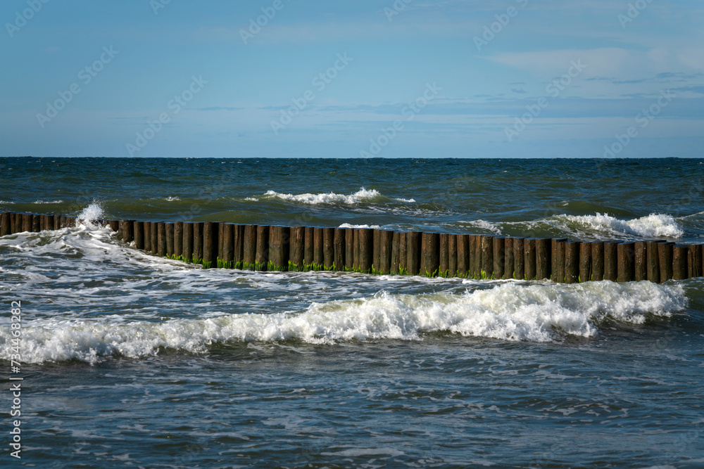 View of the Baltic Sea and wooden breakwaters of the city beach on a sunny summer day, Svetlogorsk, Kaliningrad region, Russia