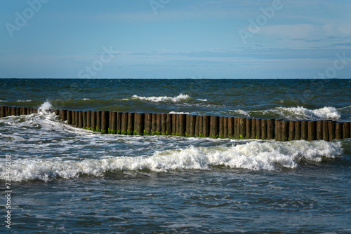 View of the Baltic Sea and wooden breakwaters of the city beach on a sunny summer day, Svetlogorsk, Kaliningrad region, Russia