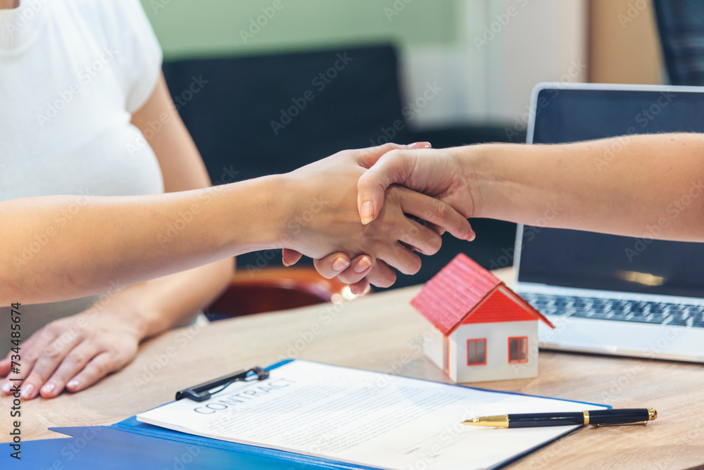 Close up Businesswoman shakes hands customer dealing real estate house