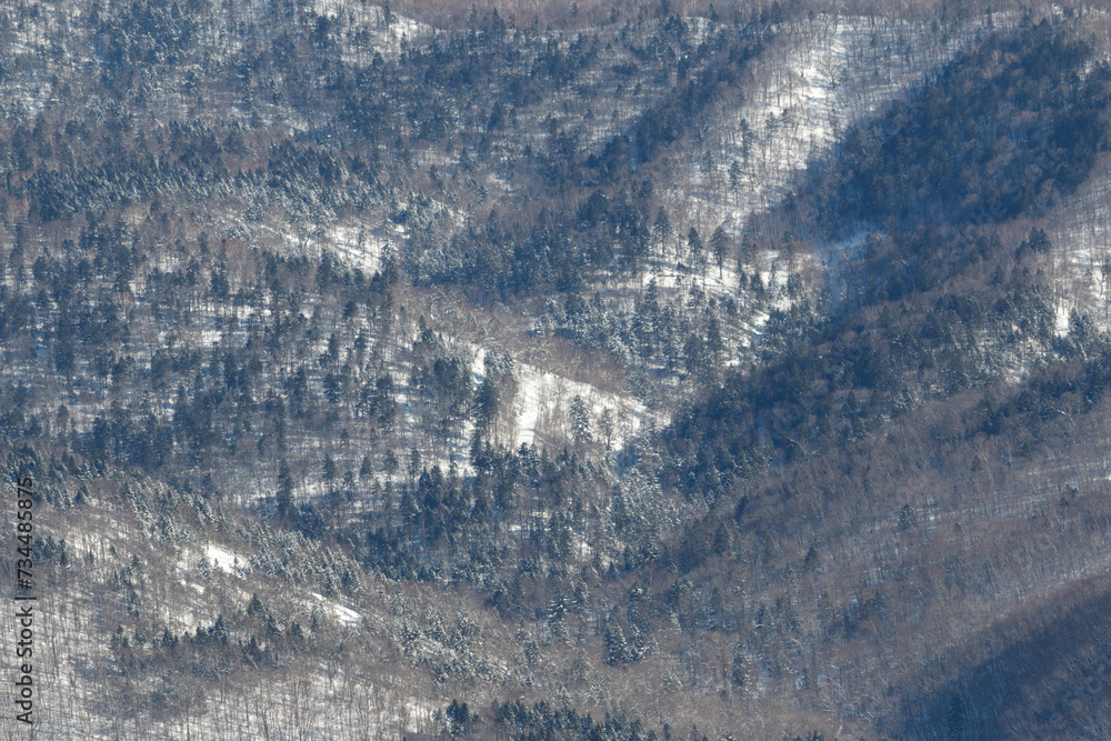 Fototapeta premium River valley winding through winter forest mountain landscape