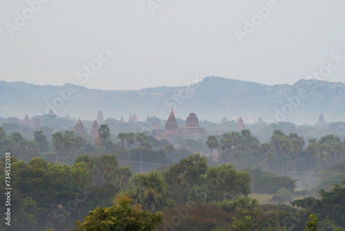 Aerial top view of burmese temples of Bagan City from a balloon, unesco world heritage with forest trees, Myanmar or Burma. Tourist destination. © tampatra
