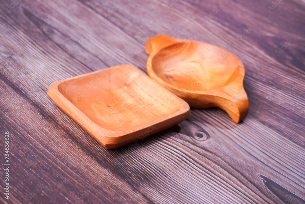 a dining place made of brown wood with various shapes on a wooden table