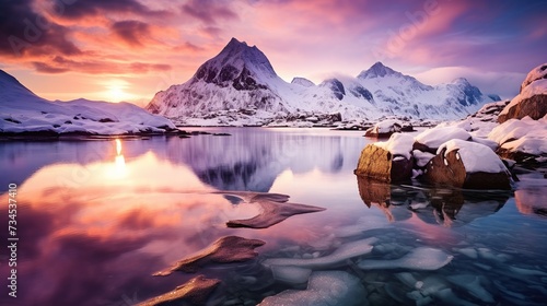 Winter landscape with snow covered rocks, fjord at night. Frozen sea coast at colorful sunset in Lofoten islands, Norway. Snowy mountains. copy space for text.