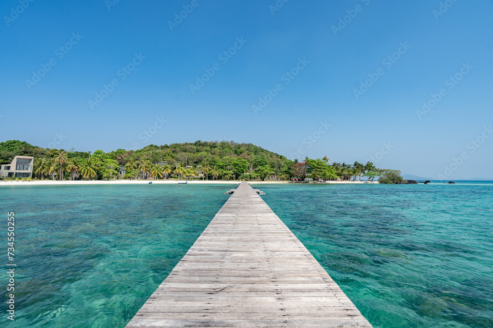 Naklejka premium A wooden harbor bridge that stretches into the sea. On Koh Mak, Trat Province, Thailand