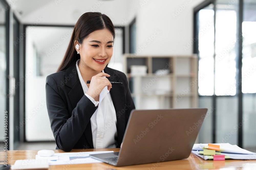 Shot of an attractive businesswoman working on laptop in her workstation Shot of an attractive businesswoman working on laptop in her workstation
