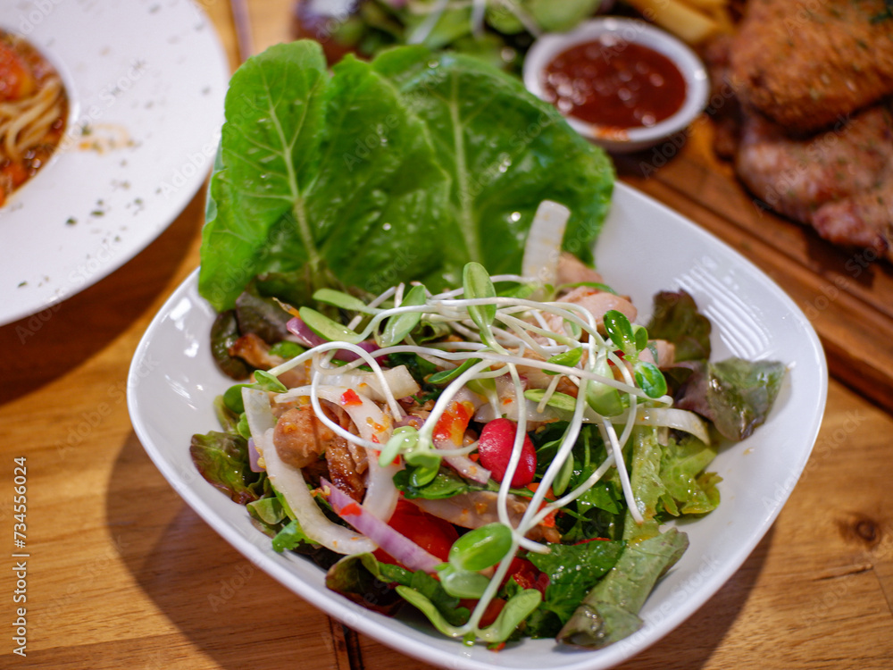 salad with tuna. Tasty healthy vegetables salad with micro greens on wooden table. salad with tuna. Tasty healthy vegetables salad with micro greens on wooden table.