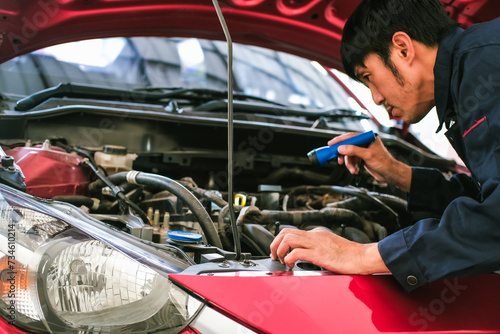mechanic inspection Shine torch car engine checking bug in engine from application UI interface smartphone.Red car service maintenance insurance fix car engine.fixing transport automobile automotive.