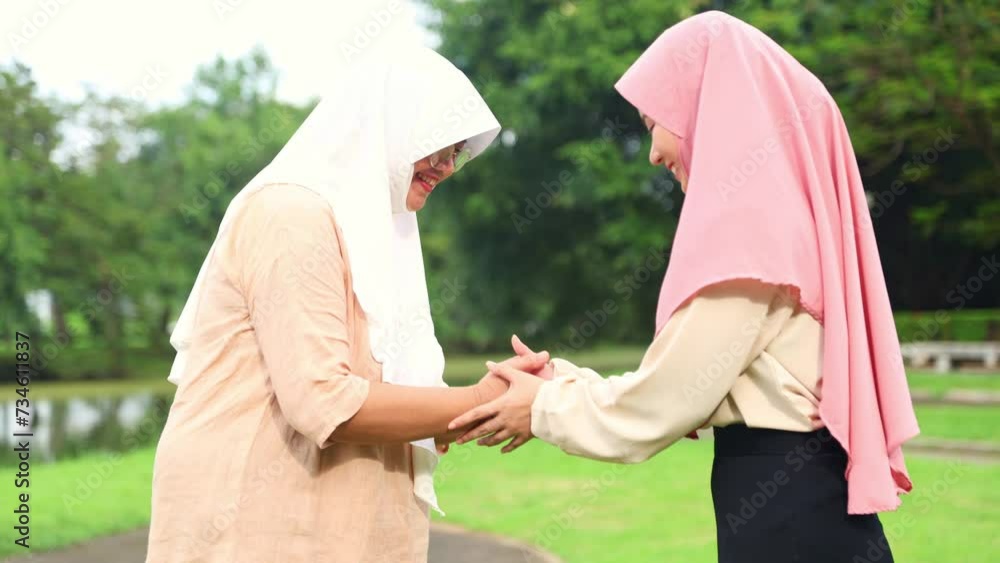 Respectful greeting two Muslim women an senior elderly woman and young