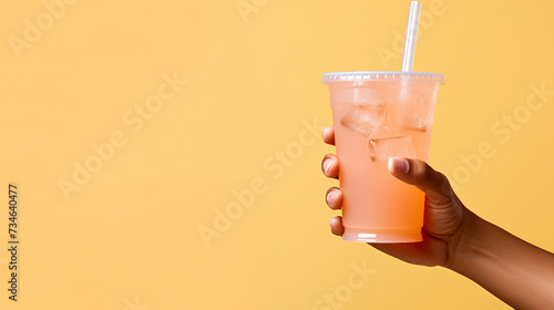 Hand holding a glass of juice photo