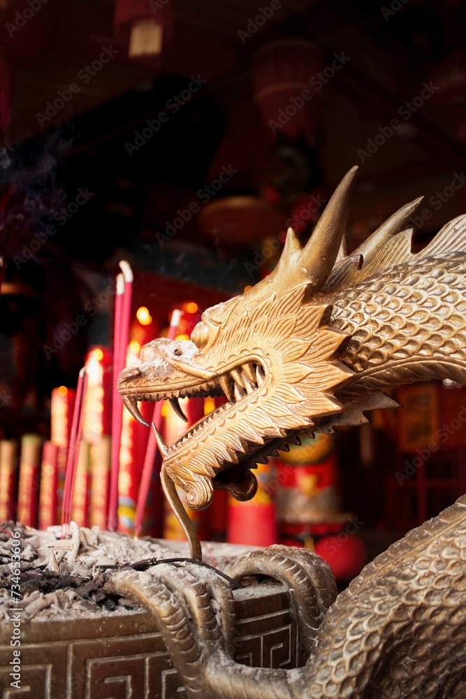 Burning prayer sticks fill the room with billowing smoke with dragon ...