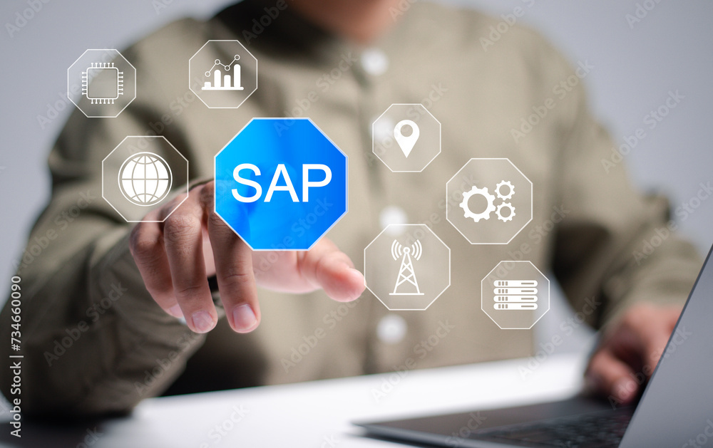 SAP or ERP enterprise resources planning system concept, Person use laptop and hand touching SAP icon on virtual screen for business process automation software and management software SAP. SAP or ERP enterprise resources planning system concept, Person use laptop and hand touching SAP icon on virtual screen for business process automation software and management software SAP.