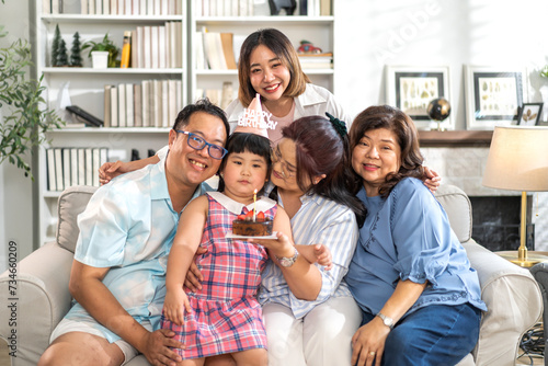 Portrait of happy love asian big family father and mother with asian baby and little girl happy birthday  party  celebration  cake  surprise  grandmother smiling together.Family party