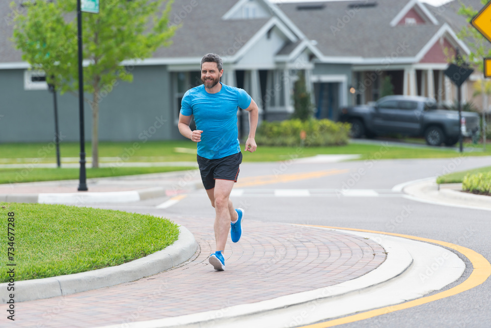 Sportsman running in the morning. Sport man training outdoor in neighborhood. Healthy lifestyle with daily fitness. Fitness and sport. Man running with energy. Sport lifestyle