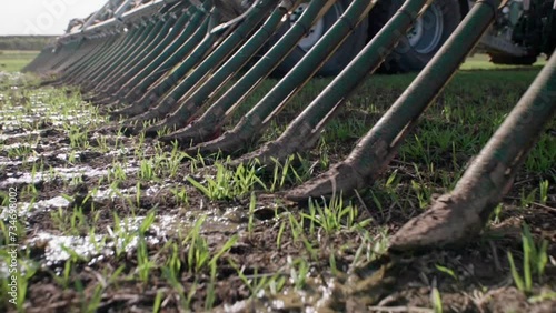 Liquid manure spreader releasing slurry on field close up slow motion