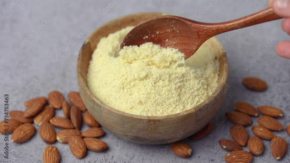 Fresh almond flour in a bowl and almonds Fresh almond flour in a bowl and almonds