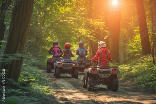 family on atvs following a forest trail together