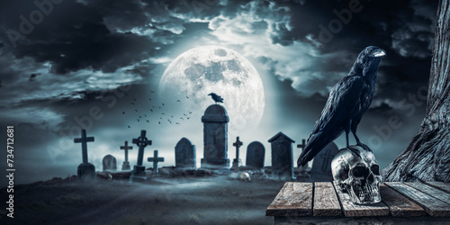 Creepy horror cemetery at night with crow on a skull