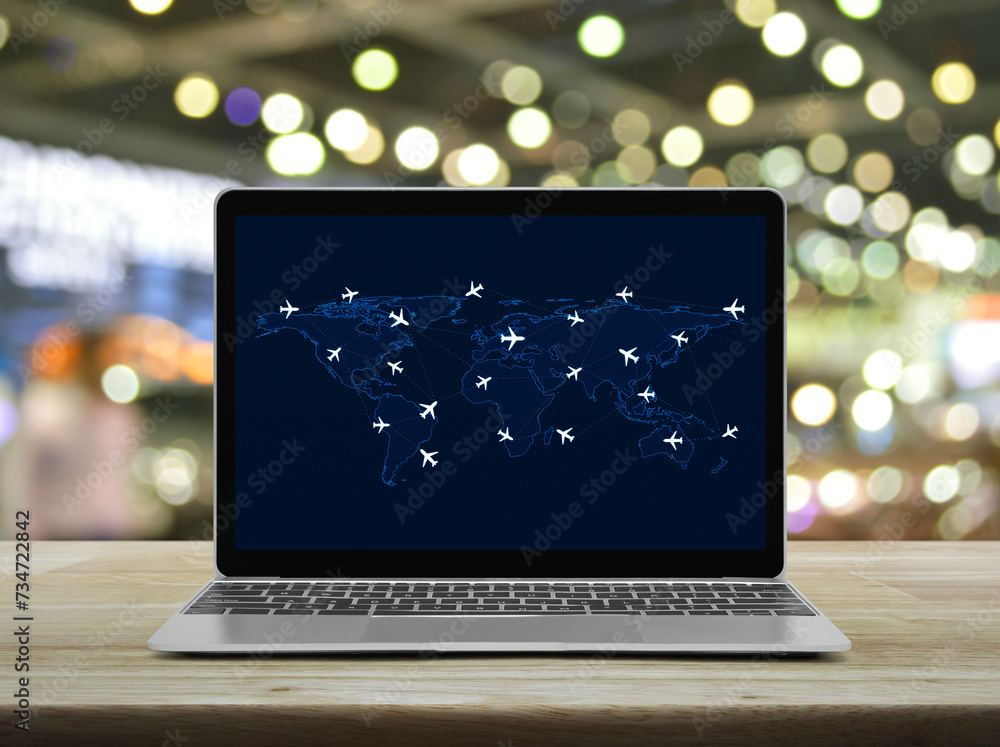 Flight routes airplanes connection and world map on laptop computer screen on table over shopping mall, Business airplane transportation network, Elements of this image furnished by NASA Flight routes airplanes connection and world map on laptop computer screen on table over shopping mall, Business airplane transportation network, Elements of this image furnished by NASA