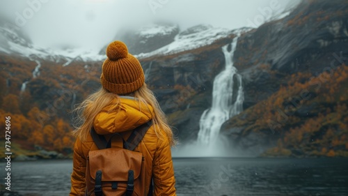 Woman sitting near Seven sisters waterfall in mountains in Norway