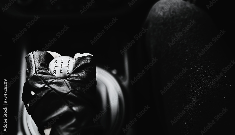 Hand on the car gear knob. The driver switches the speed in the car. Hand on gear lever. Hand on the car gear knob. The driver switches the speed in the car. Hand on gear lever.