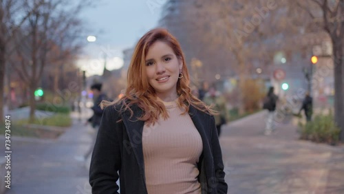 frontal posed of a beautiful woman with black coat and light brown dress