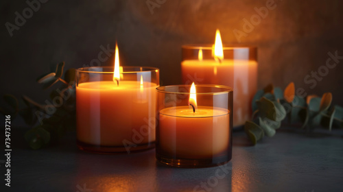 Three candles sitting on top of table. Can be used for home decor or creating cozy atmosphere