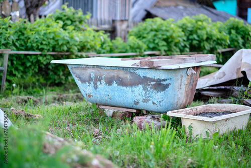 An old bathing tub is placed in the garden as a memento of a past life