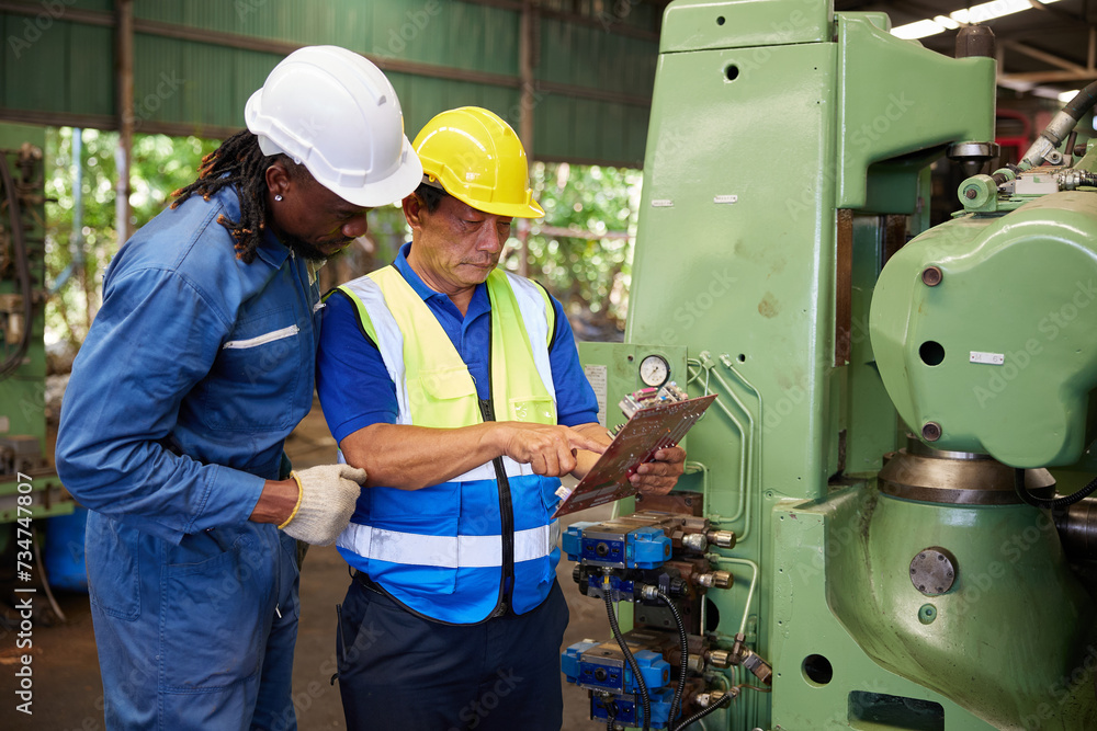 workers or technicians checking spare part and control lathe machine in the factory workers or technicians checking spare part and control lathe machine in the factory