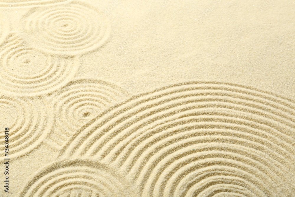 Naklejka premium Zen rock garden. Circle patterns on beige sand