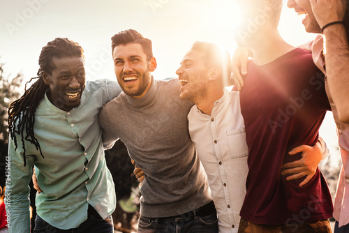 фотографія Group of multiracial men laughing together outdoors - Expression of joy and friendship among diverse friends